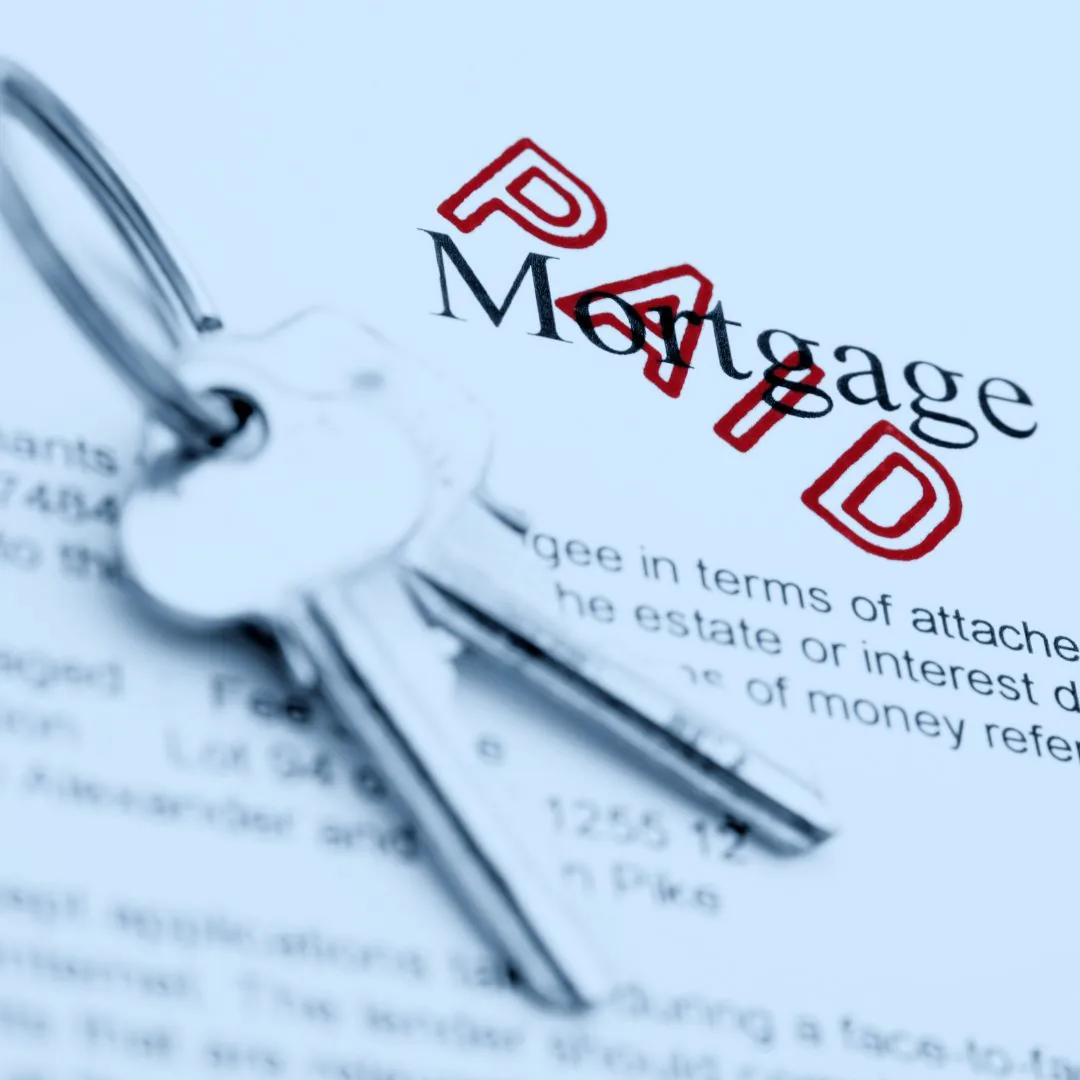 Mortgage document and house keys representing ways to pay off a mortgage faster in Canada